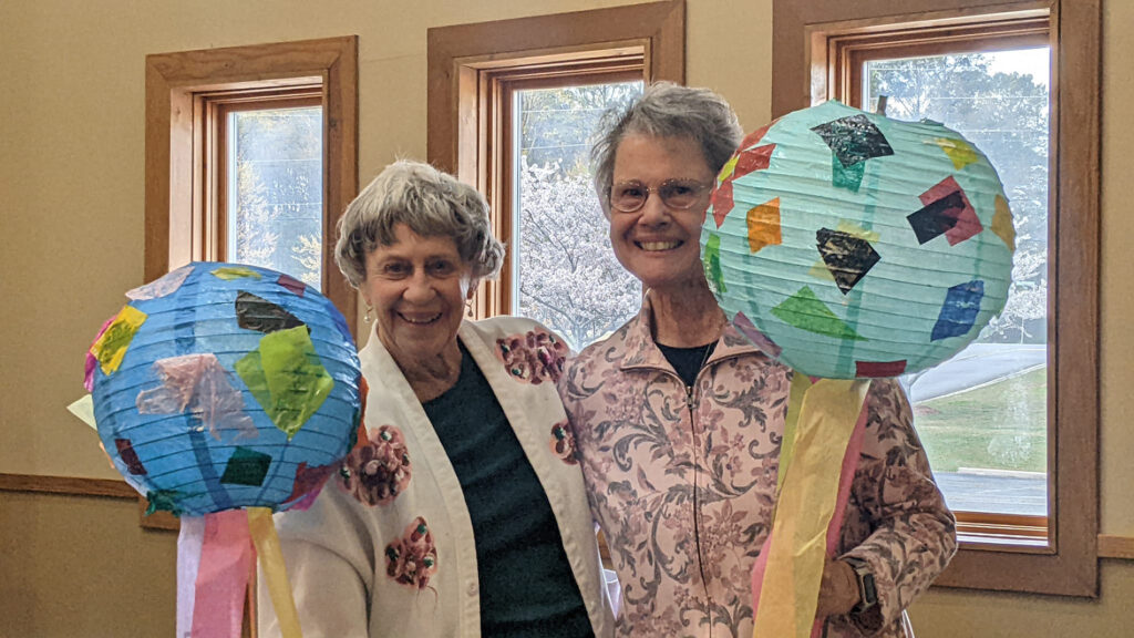 two senior women with globes